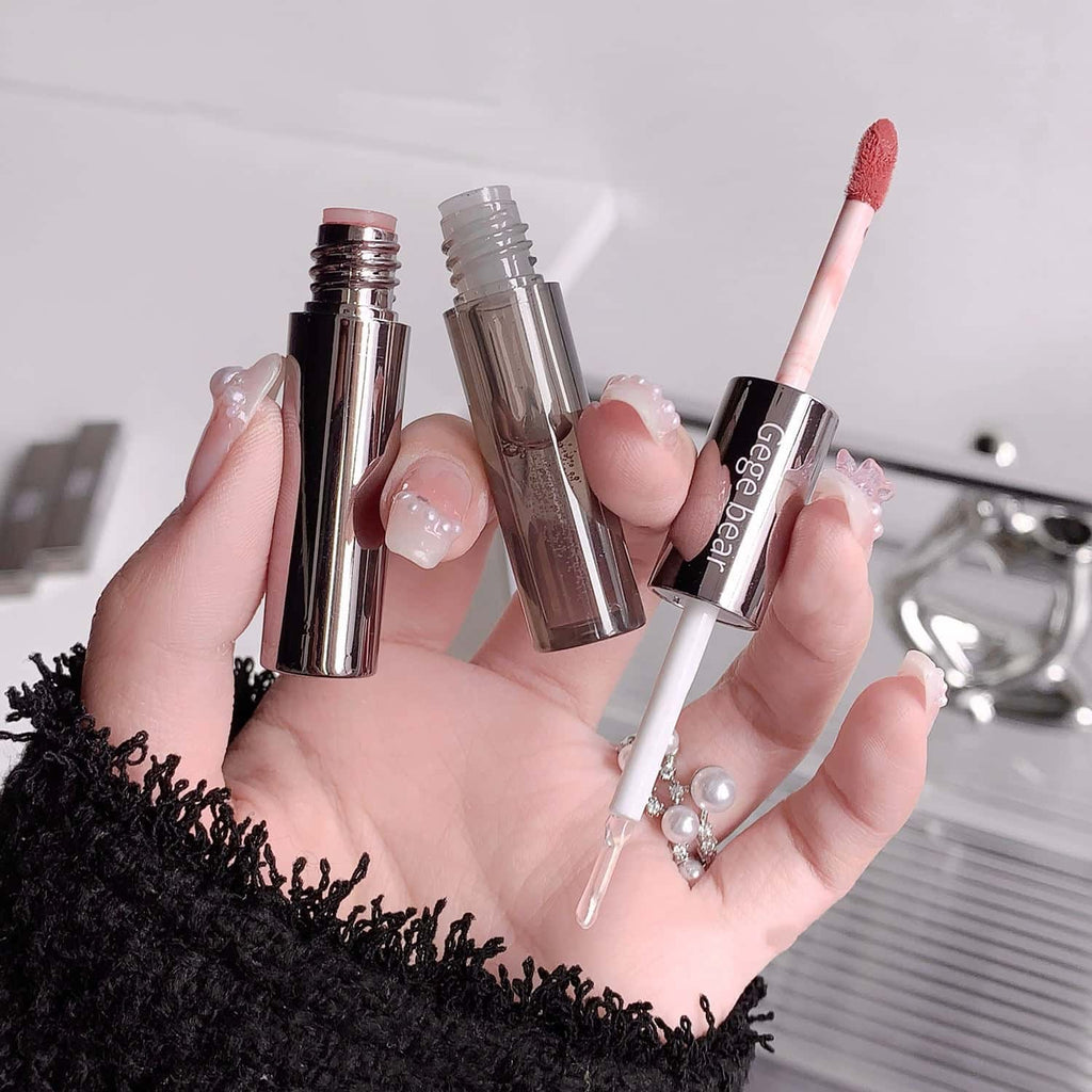 Hand holding lip gloss with visible gege bear branding against a neutral background