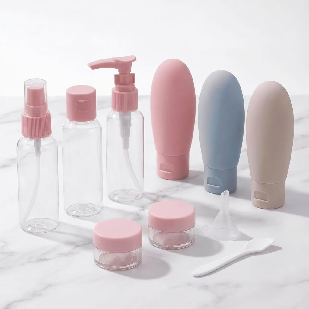 pink travel bottles and cosmeic container in white marble backgroud 