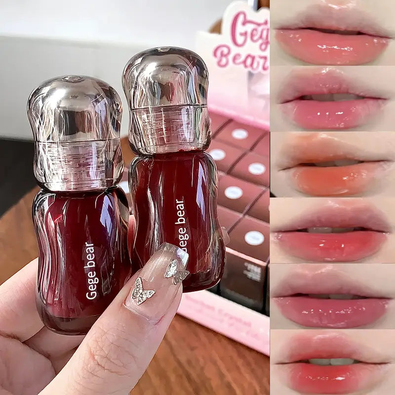 Two small red bottles of gloss with silver caps labeled 'Gege bear' held by a hand, with color swatches of pink and red lipsticks on the right.