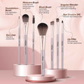 Set of Vega makeup brushes with product names and descriptions on a pink background
