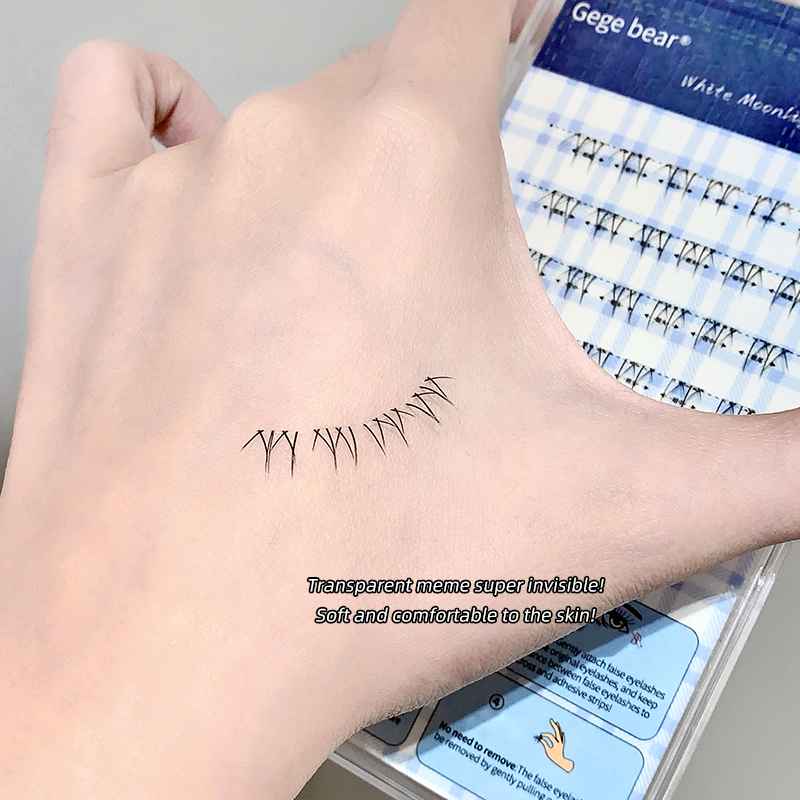 under eyelashes on a hand of a model while holding same clusters 