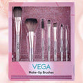 Set of Vega makeup brushes in a decorative box on a pink background