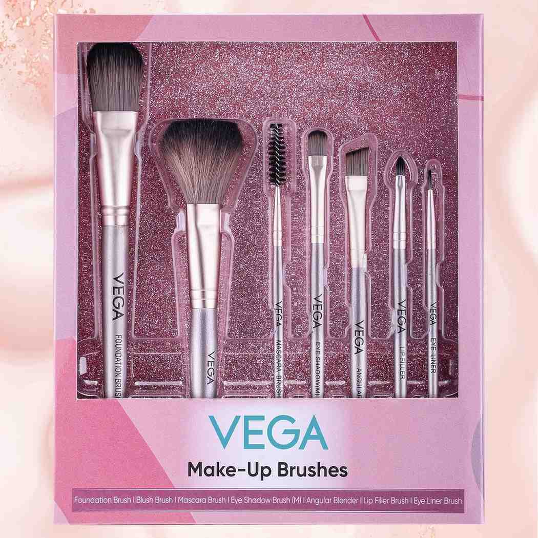 Set of Vega makeup brushes in a decorative box on a pink background
