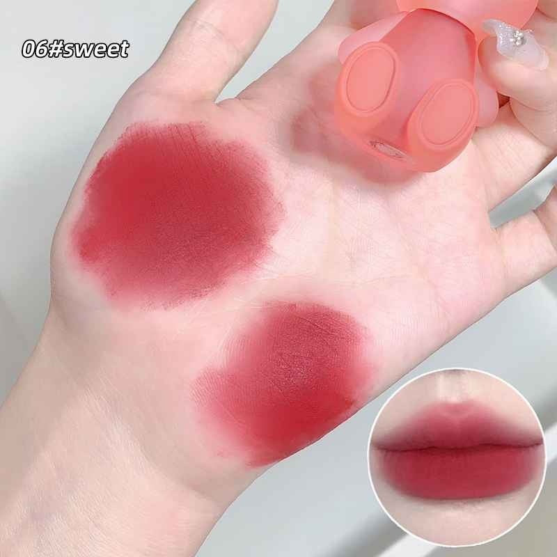 Hand with swatches of red lipstick and a close-up of lips wearing the shade.
