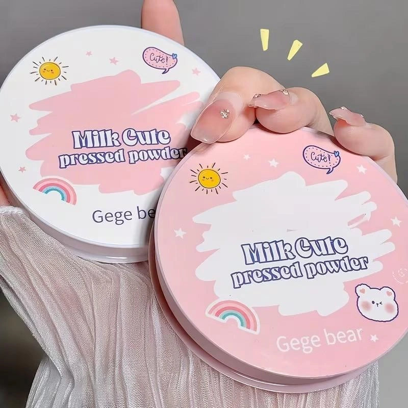 Gege Bear pink 'Milk Cute' pressed powder containers held by a hand against a gray background.