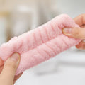 two hands pulling wristbands to show the strength and flexibility 